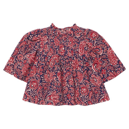 The Girls’ Jaipur Top by Pink Chicken features a red and navy paisley pattern with long bell sleeves, a round neckline, and navy glitter buttons for an elegant touch. Its loose fit offers both comfort and effortless style.