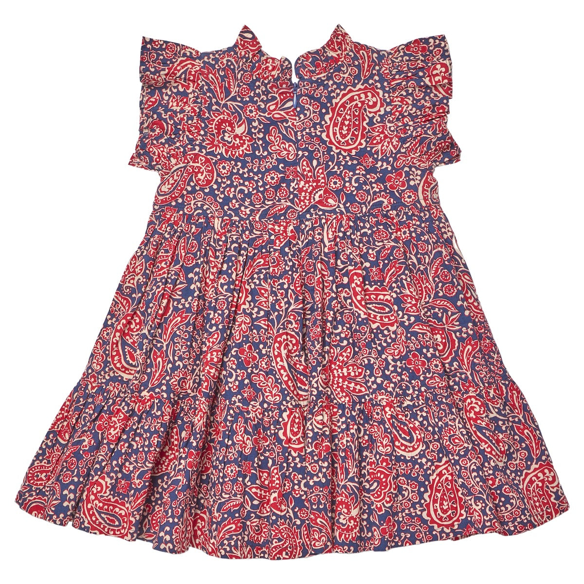 The Girls’ Jennifer Dress by Pink Chicken features short sleeves with ruffles, a red and white paisley vines pattern on a blue background, and a slightly flared, tiered skirt.