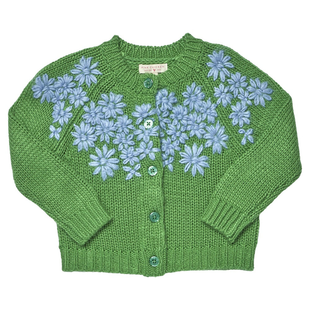 The Girls’ Blossom Sweater by Pink Chicken is a green button-down cardigan for girls, featuring blue floral embroidery on the front, four coordinating green buttons, and long sleeves.