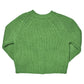 The Girls’ Blossom Sweater by Pink Chicken is laid flat with the front side visible, featuring a green floral design and ribbed cuffs, hem, and collar.