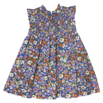 The Girls’ Stevie Dress by Pink Chicken is sleeveless, pleated, and floral with a smocked chest and playful ruffled shoulders.