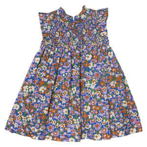 The Girls’ Stevie Dress by Pink Chicken is sleeveless, pleated, and floral with a smocked chest and playful ruffled shoulders.