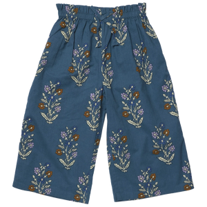 Girls’ Theodore Pant by Pink Chicken with paperbag elastic waist, front drawstring, and floral print in brown, white, purple, and green.