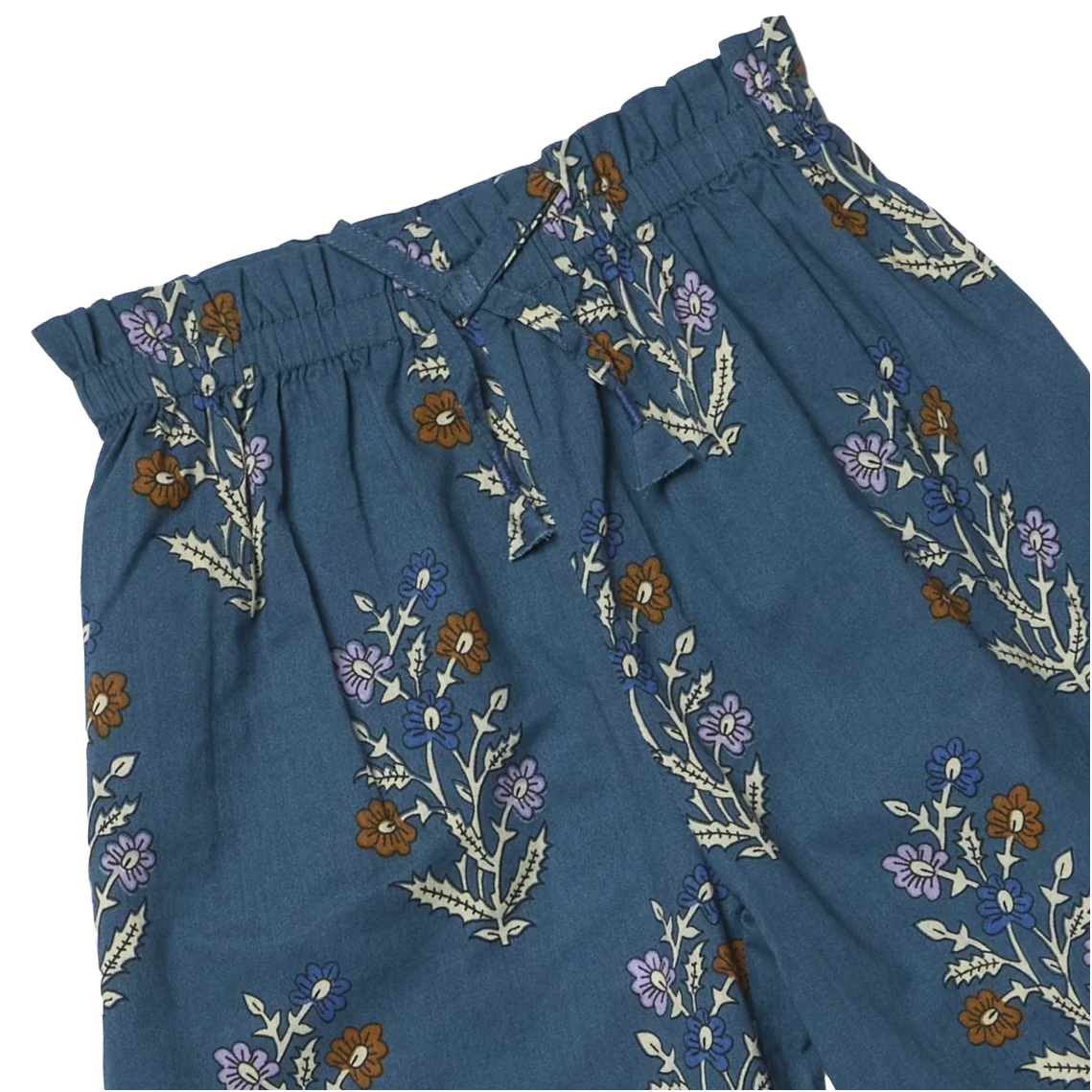 Girls’ Theodore Pant by Pink Chicken in blue has an elastic waist and a floral print with brown, purple, and white flowers on green stems.