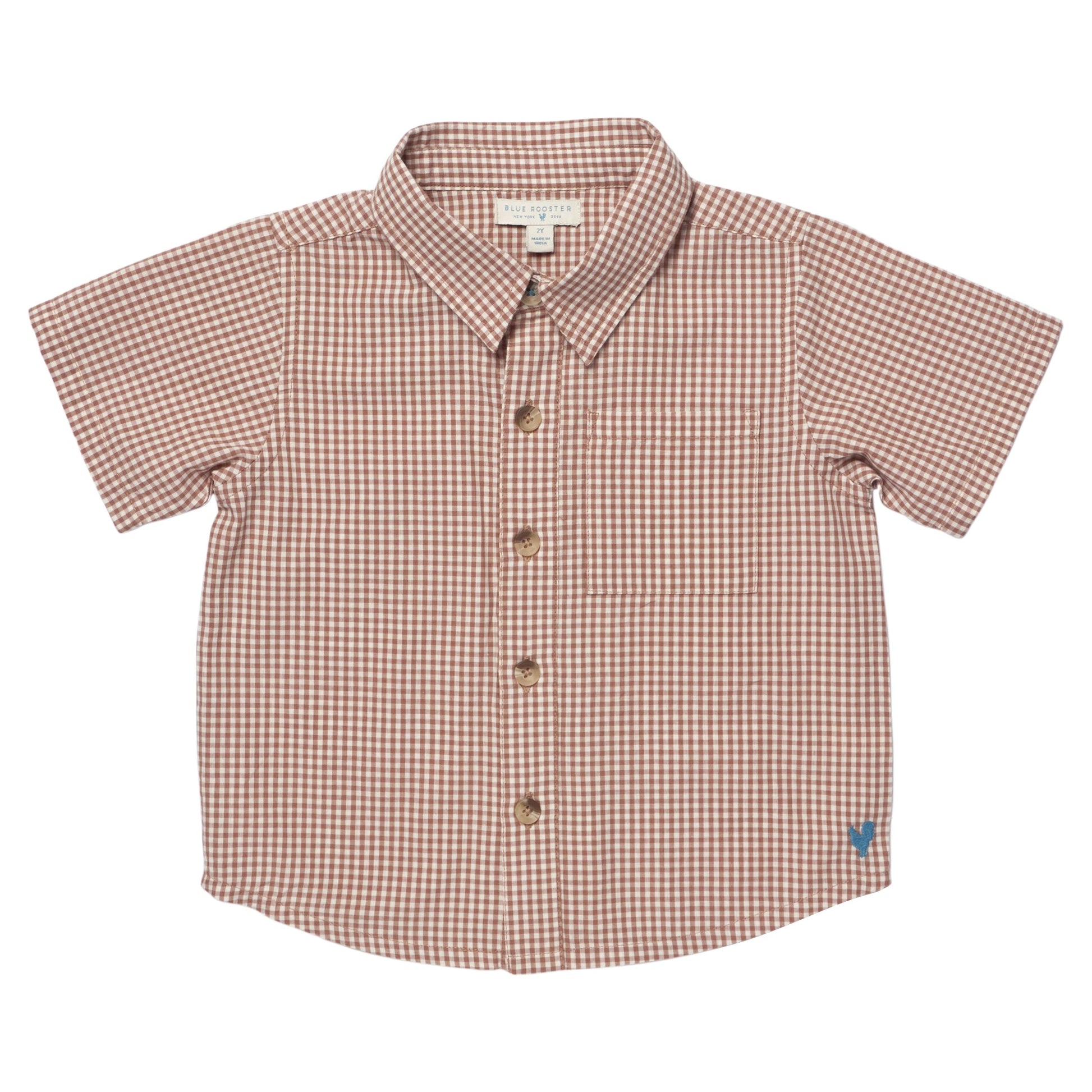 The Pink Chicken Boys' Jack Shirt in Cocoa Gingham features short sleeves, a collar, brown and white checkered pattern, and a blue heart logo on the lower right side.