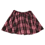 A Pink Chicken Girls’ Gianna skirt featuring a pleated, pink and dark green tartan plaid pattern with an elastic waistband.