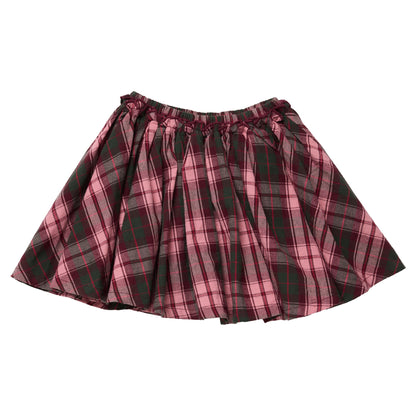 A Pink Chicken Girls’ Gianna skirt featuring a pleated, pink and dark green tartan plaid pattern with an elastic waistband.