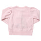 Pink Chicken Girls’ Constance sweater in light pink with puffed shoulders, ribbed trim, and velvet bows.
