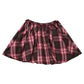 Pink Chicken Girls’ Gianna Skirt in burgundy tartan with a pleated design, pink and dark green plaid pattern, and an elastic waistband.