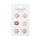 A white card labeled “Kids’ Bike Basket Pins” by Banwood displays six daisy-shaped pins in pink, brown, and beige tones, arranged in two columns and three rows—the perfect collectible accessory for your Pin & Ride Baskets.