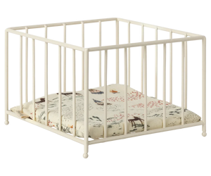 The Maileg Playpen, Micro by Maileg is a white square baby playpen with vertical bars and a cushioned base featuring a nature-themed print, perfect also as a small animal play area.