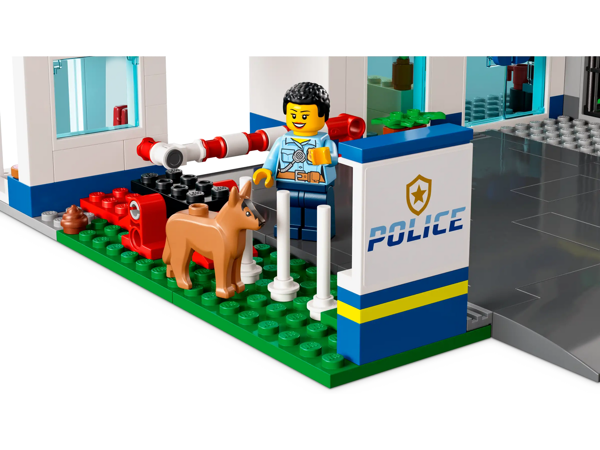 A toy police officer from the LEGO® City Police Station by Legos - Toyhouse stands proudly outside, petting a loyal police dog as a helicopter hovers in the background.