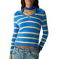 A woman wears the Port Polo by Guest in Residence: a blue and yellow striped cashmere sweater, paired with blue jeans, a blue bandana, and a gold necklace—showcasing timeless style in lightweight luxury.