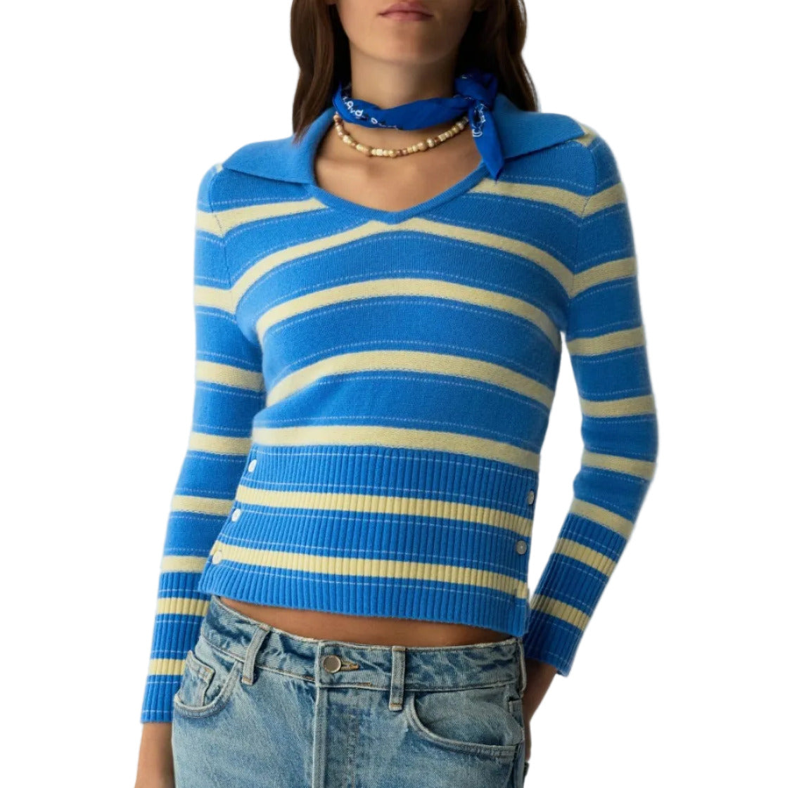 A woman wears the Port Polo by Guest in Residence: a blue and yellow striped cashmere sweater, paired with blue jeans, a blue bandana, and a gold necklace—showcasing timeless style in lightweight luxury.