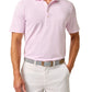 A man in a Johnnie-O Stetsons Polo, featuring light pink stripes and crafted from lightweight, moisture-wicking fabric with a collar and three buttons, stands with one hand in his pocket while wearing white pants. His belt showcases a geometric design.