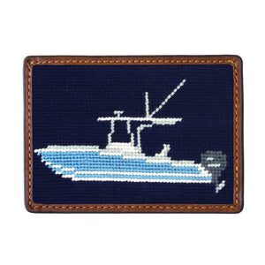 Smathers & Branson’s Card Wallet features a rectangular needlepoint design with hand-stitched blue and white boat imagery on a navy background, accented by brown leather trim. This wallet blends nautical-inspired style with classic craftsmanship.