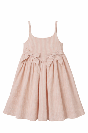 Noralee Girls' Beatrice Midi Dress in light pink features spaghetti straps, two front bows at the waist, and a full gathered skirt, shown against a white background.