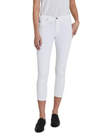 A person stands upright against a plain background wearing the Prima Crop Luscious Super Stretch Sateen by AG Jeans, paired with a white top and black shoes.