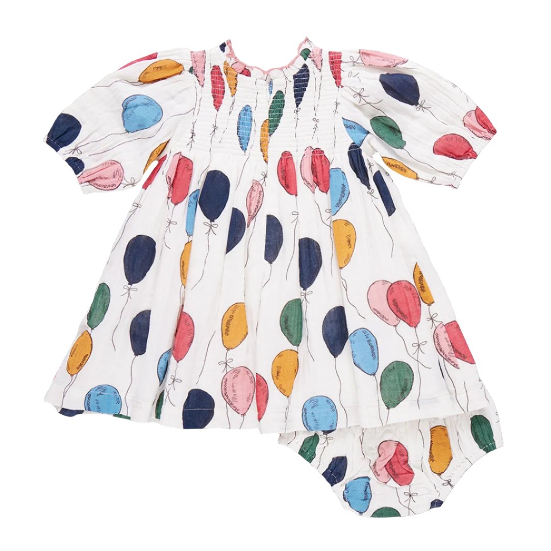 The Pink Chicken Baby Girls' Stevie Puff Sleeve Dress Set showcases a vintage-inspired smocked front with a charming Balloon Bunches print and comes complete with a matching bottom.