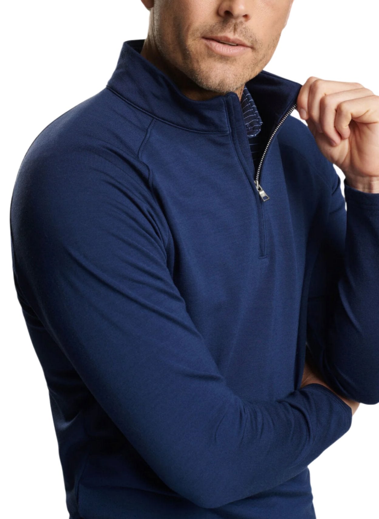 A Peter Millar enthusiast confidently crosses their arms while sporting a partially unzipped Excursionist Flex Performance Pullover in navy blue.