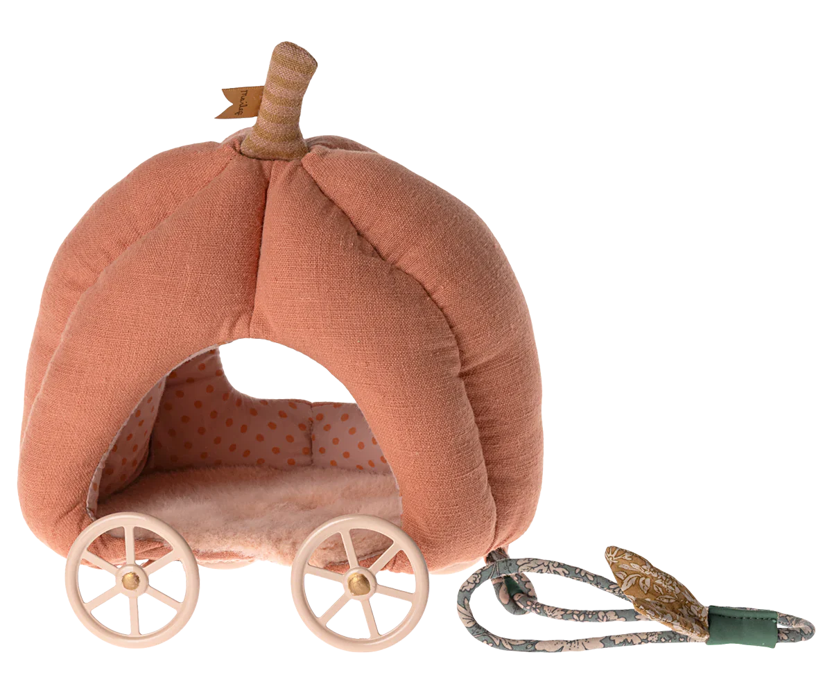 The Maileg Pumpkin Carriage, Mouse, by Maileg is a pink, pumpkin-shaped plush fairytale carriage featuring white wheels and a pull cord. The interior boasts a charming polka dot pattern, making it the perfect toy for kids.