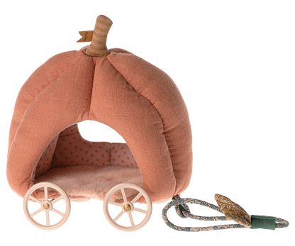 The Maileg Pumpkin Carriage, Mouse, by Maileg is a pink, pumpkin-shaped plush fairytale carriage featuring white wheels and a pull cord. The interior boasts a charming polka dot pattern, making it the perfect toy for kids.