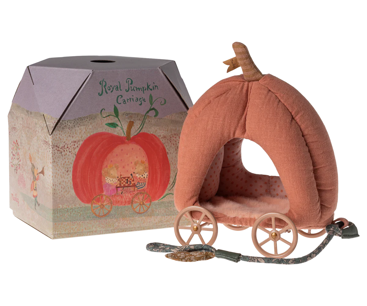 A small Maileg Pumpkin Carriage, Mouse with wheels is shown next to a decorative box labeled "Royal Pumpkin Carriage." The plush pink interior and fairytale design make it a charming toy for kids, resembling a delightful royal mice carriage by Maileg.