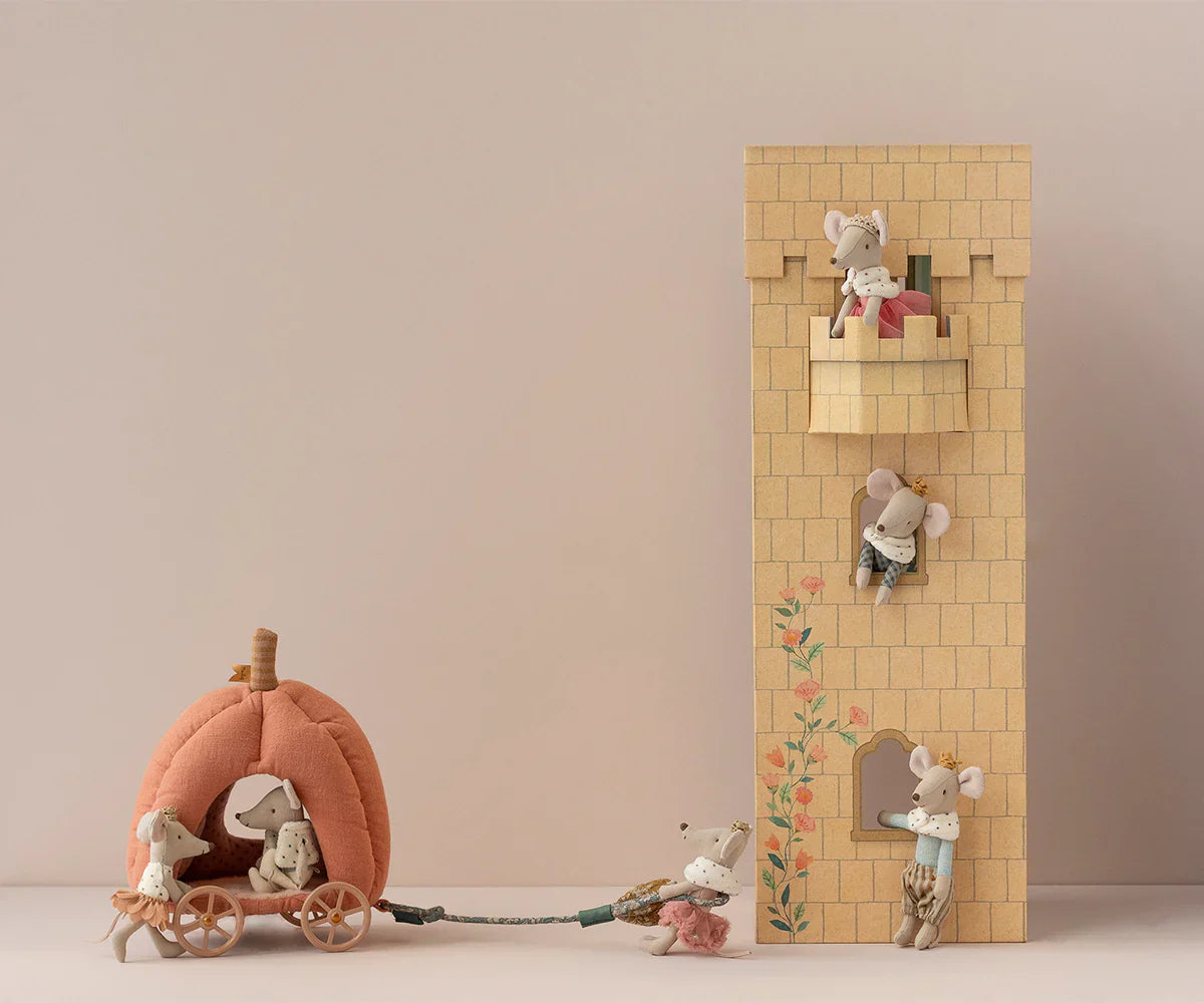 Various toy mice interact with the Maileg Pumpkin Carriage, Mouse, and a block tower, creating a playful scene reminiscent of a fairytale. This enchanting royal mouse carriage from Maileg makes it an ideal toy for kids.