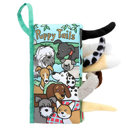 The Jellycat Puppy Tails Book by Jellycat is a soft, fabric baby book showcasing illustrated puppies with fluffy tails and different textures. Infants will enjoy discovering each page's distinct design and tactile surprises, including the crinkle panels.