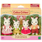 Boxed set of four Calico Critters Chocolate Rabbit Family posable figures, dressed in colorful clothes, with a background featuring a house and trees. Perfect for any fan of collectible toys.