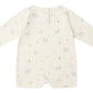The Quincy Mae Baby Long Sleeve Romper in cream features an all-over pastel print with bears, trees, and shapes. Displayed flat with the back side up, it's perfect for everyday wear and easy changing.