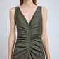 A person wears the Remi Dress by Proenza Schouler, an olive green, sleeveless design with a deep V-neckline and gathered ruching down the front, crafted from Eco Stretch Linen.
