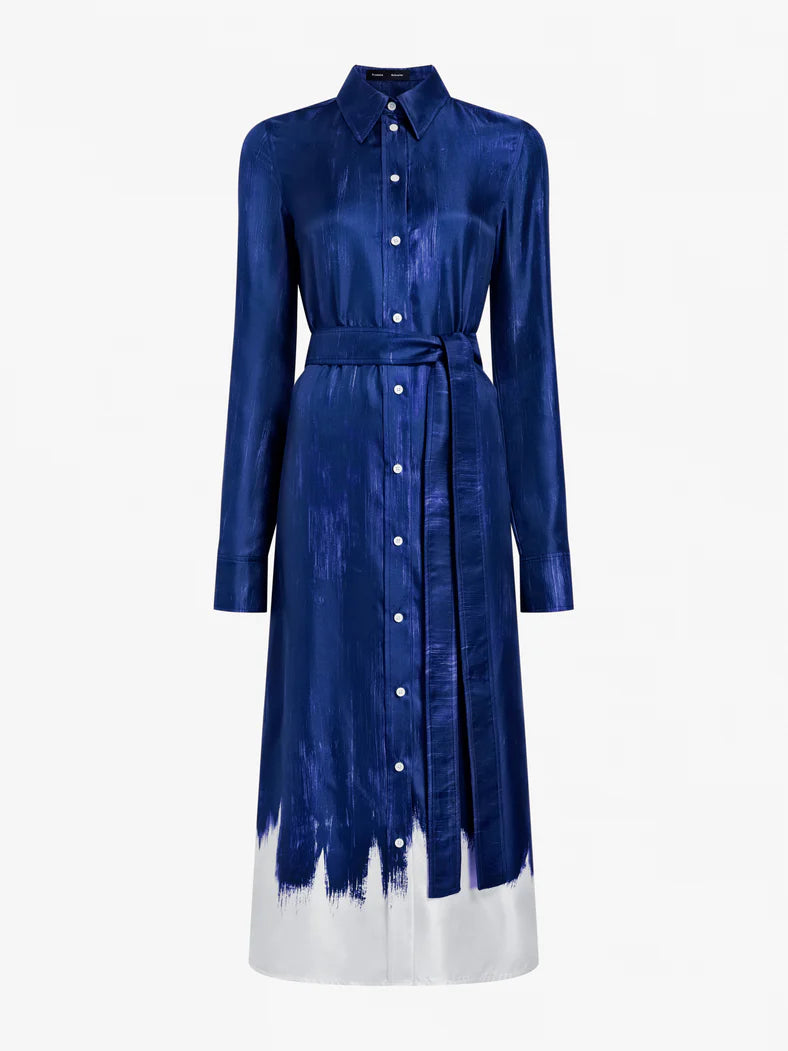 The Amaya Silk Twill Dress by Proenza Schouler is a blue, long-sleeved, button-down shirtdress with a tie belt and white color-block hem accented by brush stroke details.