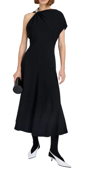 Wearing the Proenza Schouler Rue Light Matte Double Crepe Dress, holding a small black clutch, and pairing it with white low-heeled shoes and black tights.