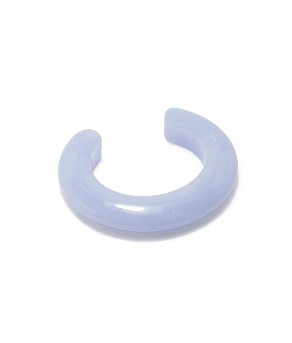 The Lizzie Fortunato Ridge Cuff is a thick, translucent light purple resin bracelet with a glossy finish, ideal for stacking with other bracelets and shown on a white background.