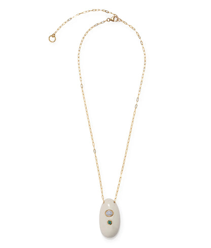 La Paz Pendant Necklace by Lizzie Fortunato: gold-plated chain with a white oval ceramic talisman featuring two inset stones—one iridescent, one green—set against a white background.