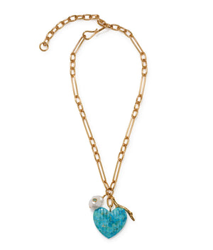 The Floria Heart Necklace by Lizzie Fortunato features a gold-plated chain, turquoise heart pendant with blue mosaic, white flower charm, and adjustable clasp—an ideal statement piece for any occasion.