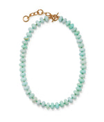 The Tola Necklace by Lizzie Fortunato features round light aqua-blue Peruvian opal beads and a gold-plated brass chain clasp, shown on a white background.