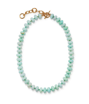 The Tola Necklace by Lizzie Fortunato features round light aqua-blue Peruvian opal beads and a gold-plated brass chain clasp, shown on a white background.