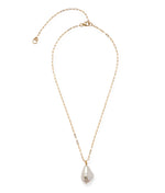 The Lizzie Fortunato Oasis Necklace is a gold paperclip chain with a single irregular baroque pearl pendant, offering a modern yet timeless touch.