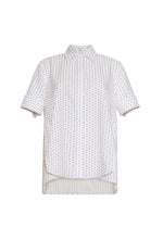 The Trapeze Sashiko Stripe Shirt by Adam Lippes features short sleeves, a collared button-up design, chic stripes, an architectural silhouette, and a slightly longer back hem, all crafted from fine Italian cotton.
