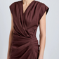 A person wearing the Proenza Schouler Bettina Dress, a sleeveless deep burgundy wrap made from Eco Stretch Viscose Linen with gathered waist detail, photographed from shoulders to mid-thigh.