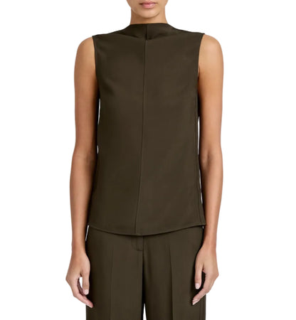 A person wears the Proenza Schouler Defni Top—a sleeveless, draped high-neck design in dark olive green Eco Hammered Viscose—paired with matching trousers, seen from the front against a white background.