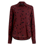 The Proenza Schouler Paz Printed Dot Shirt is a maroon, long-sleeve button-up in stretch viscose with a black polka dot print, shown on a plain white background.