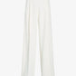 The Halima Pant by Proenza Schouler is a pair of white, high-waisted trousers crafted from matte double crepe with wide legs, front pleats, and belt loops, shown against a plain white background.