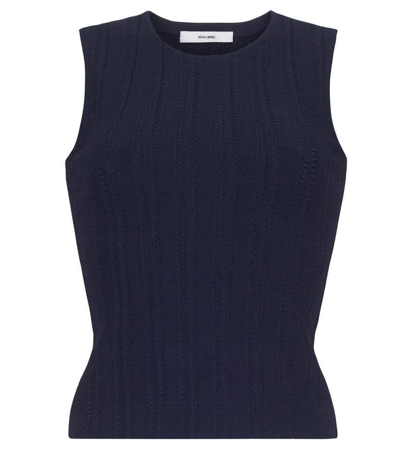 The Brynn Compact Jacquard Knit Top by Adam Lippes is a sleeveless navy shell with a crew neckline, fitted bodice, and subtle vertical rib-stitch jacquard texture.