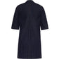 The Lauder Dress by Adam Lippes is a dark blue, knee-length denim dress in Japanese indigo with short sleeves, a central back pleat, and subtle topstitching.
