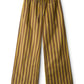 The Mateo Cotton Poplin Pant by Staud features a wide-leg, mid-rise silhouette with vertical mustard yellow and brown stripes, crafted from soft cotton poplin and finished with an elastic drawstring waist.