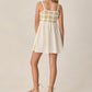 A teen girl wears the Rylee & Cru Crochet Sundress, featuring a patterned bodice, and flat sandals as she stands with her back to the camera against a neutral background.