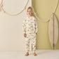 A child stands barefoot indoors wearing the Rylee & Cru Baby Boys' and Boys' Relaxed Sweatshirt with an alligator print, next to a surfboard and decorative ropes on a pale green and white background.